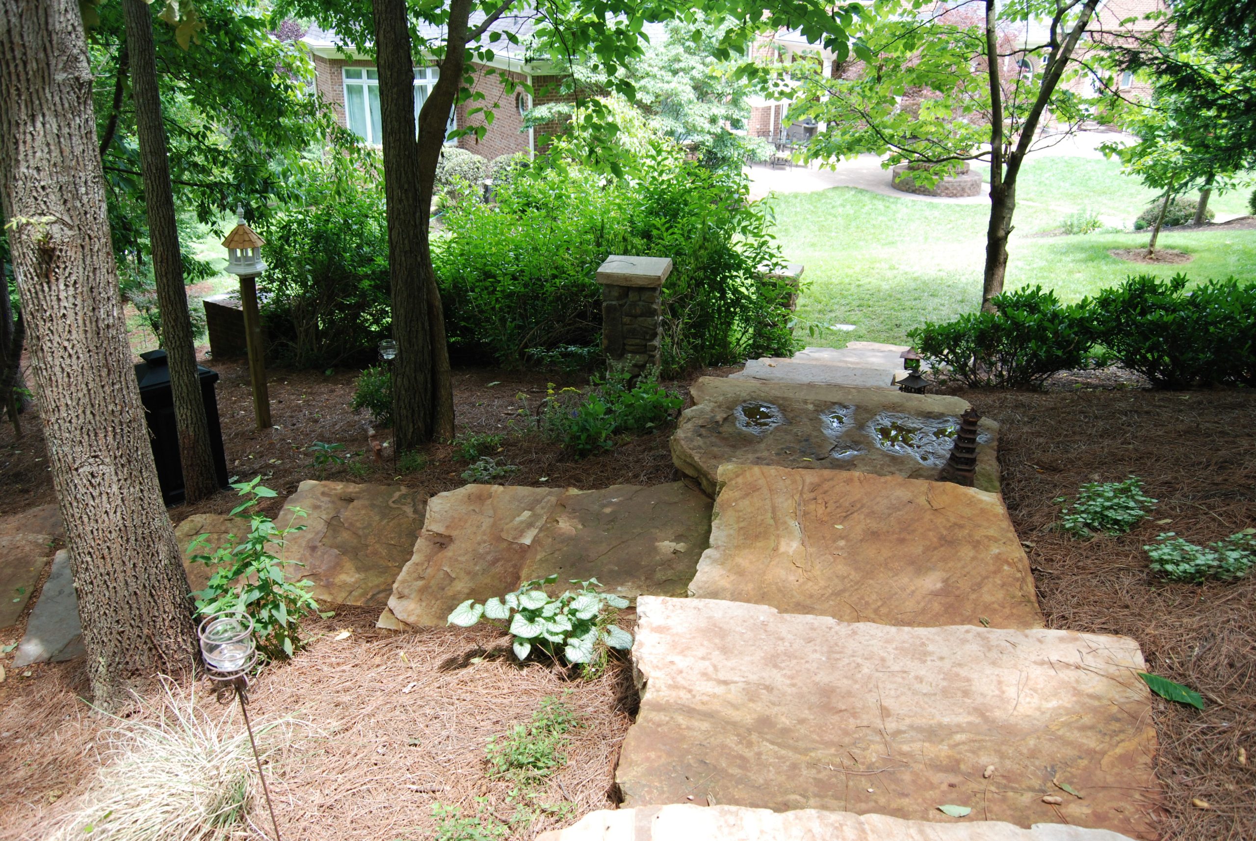 Flagstone path through a landscaped garden bed